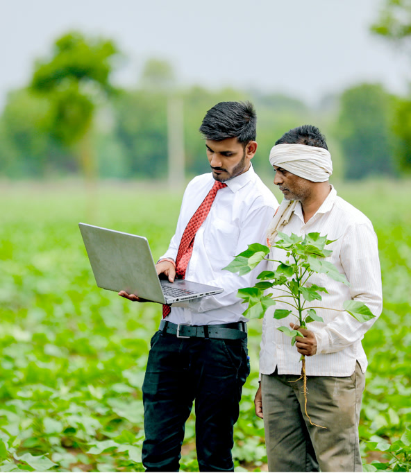 Rural entrepreneur helping a farmer with digital tools