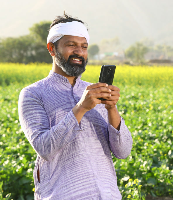 Farmer accessing agricultural services on his phone